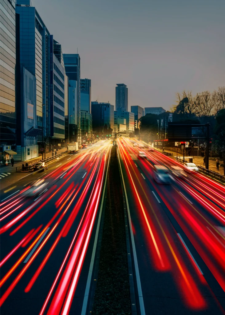 light trail photography of cars on a highway in a city symbolizing the shift toward e-hailing services.